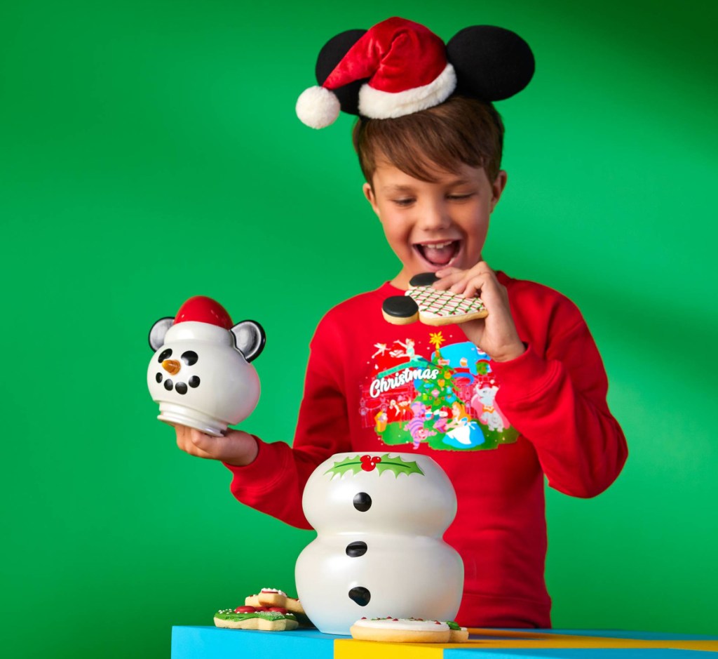 boy taking cookie from snowman cookie jar