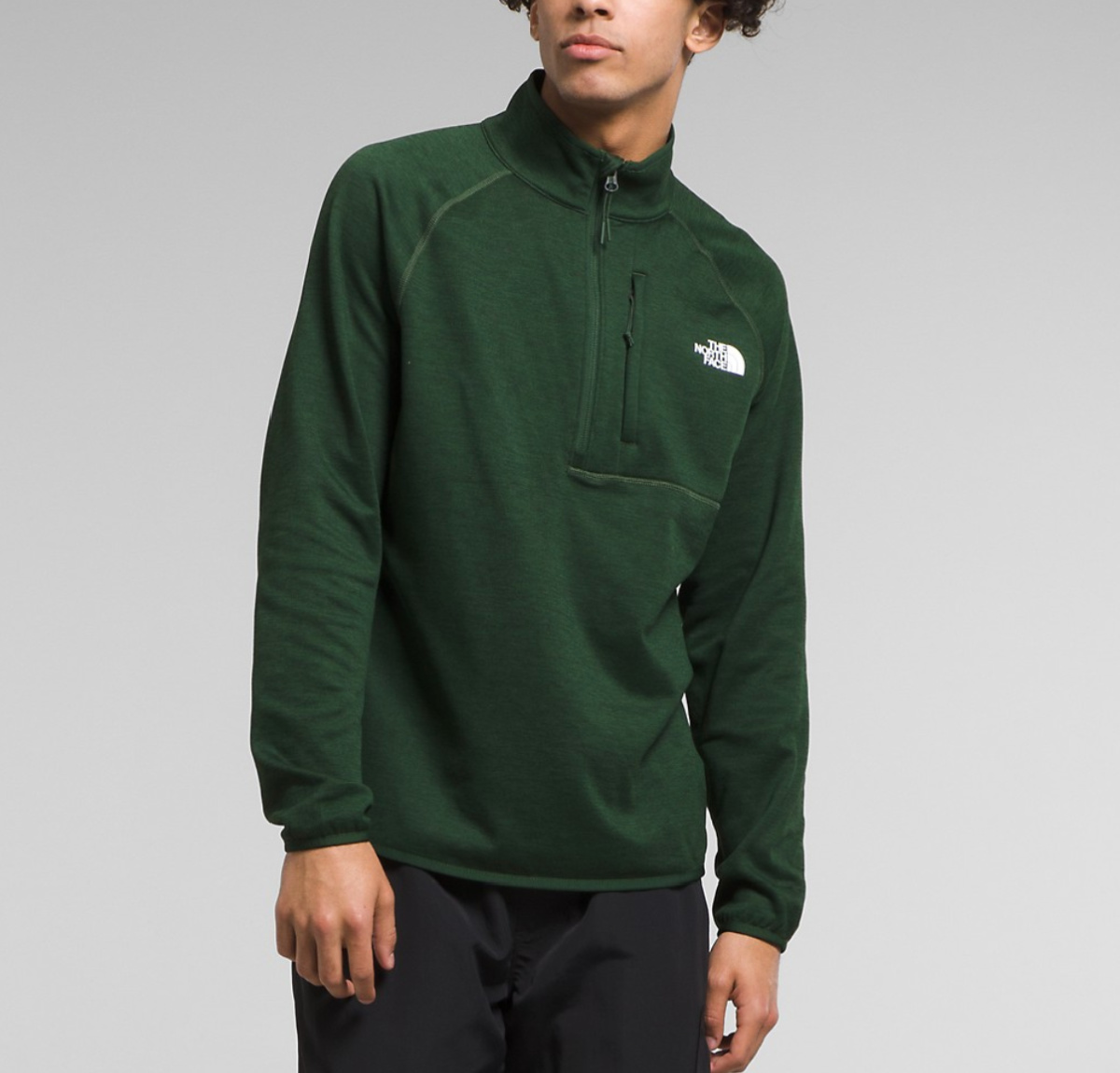 man in hunter green zip fleece