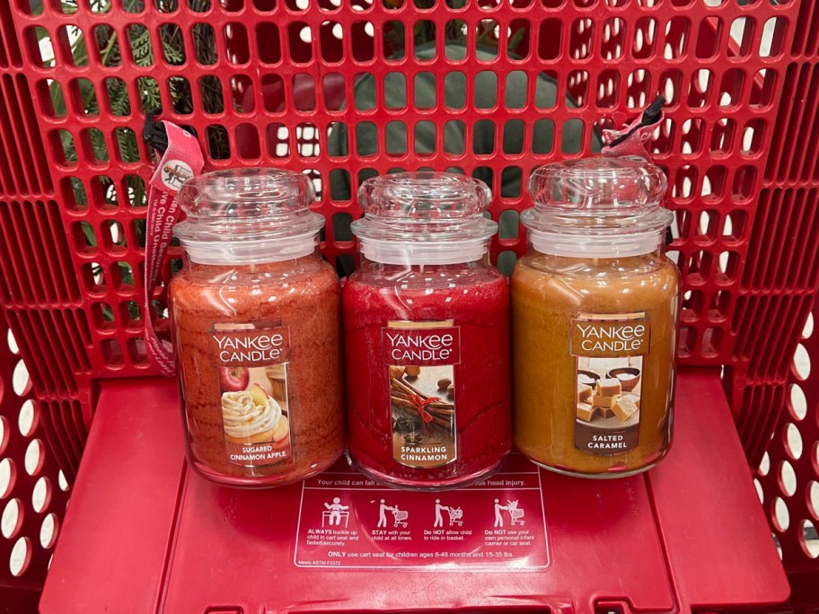 three different scents of Yankee candles inside of target cart