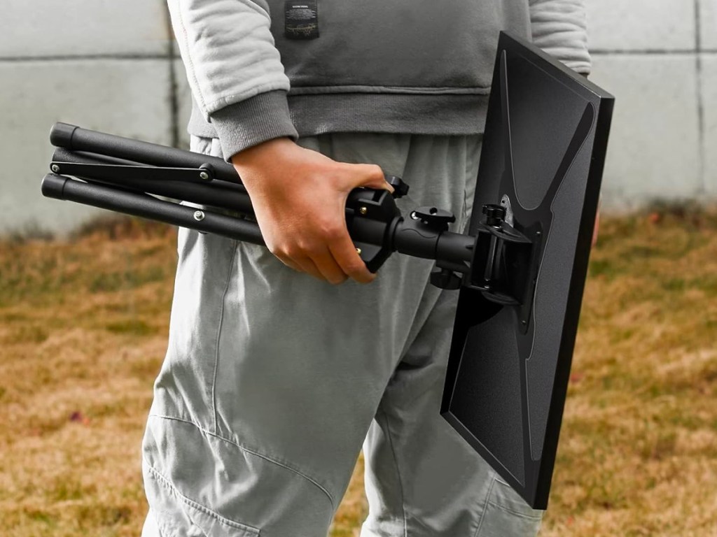 man holding tripod in hands