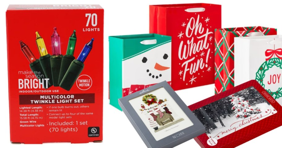 a red box with multi-color Christmas string lights, holiday gift bag set, and a boxes of Christmas cards