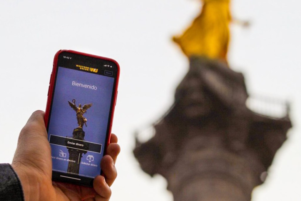 holding up phone in front of statue