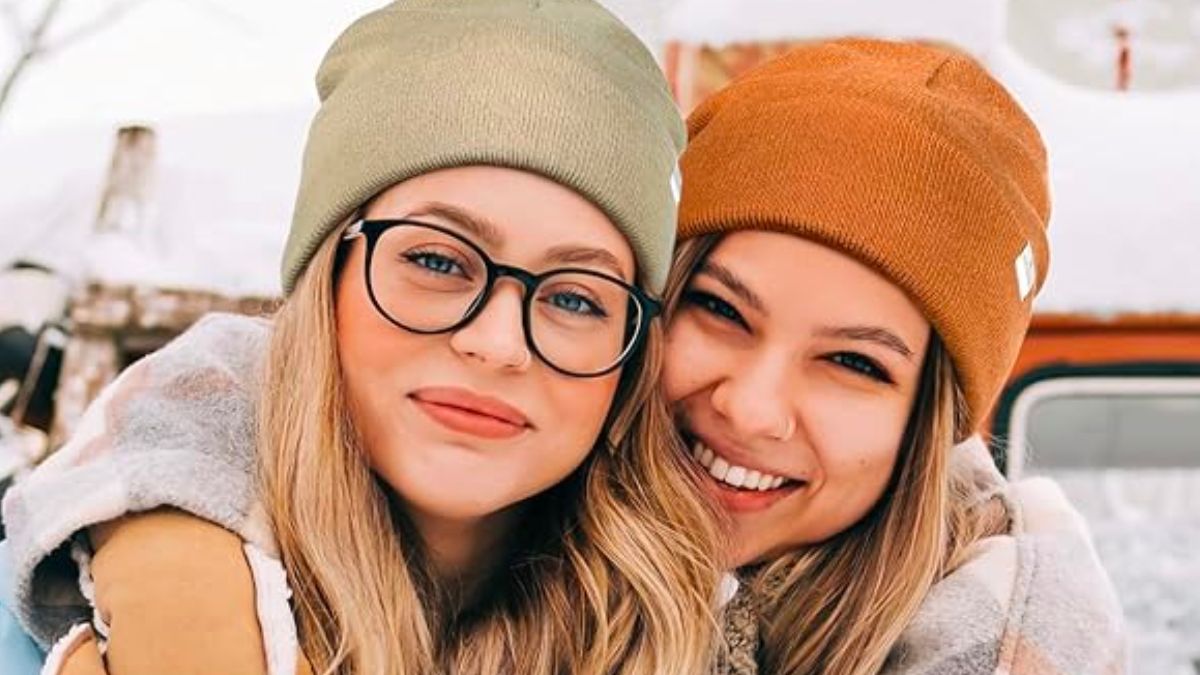 2 women wearing satin lined beanies