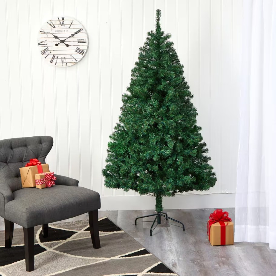 a green artificial Christmas tree in a living room