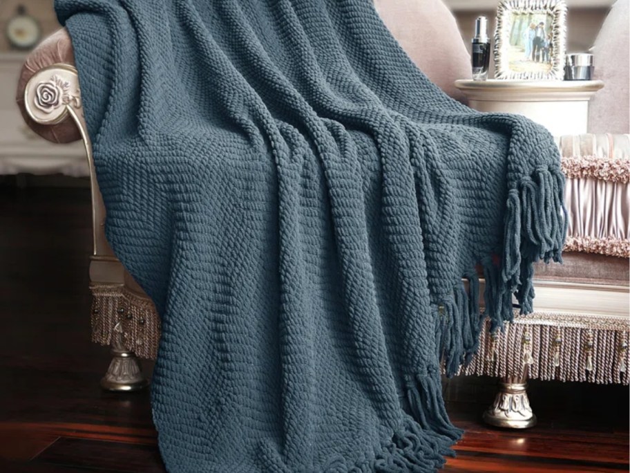 dark blue knitted throw blanket on an accent chair