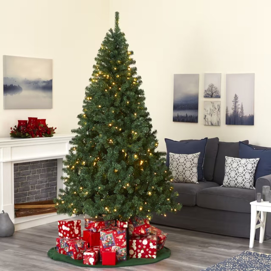 large green artificial christmas tree with clear lights in a living room