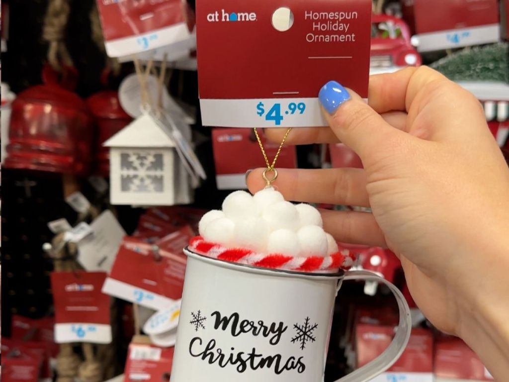 hand holding up christmas mug ornament