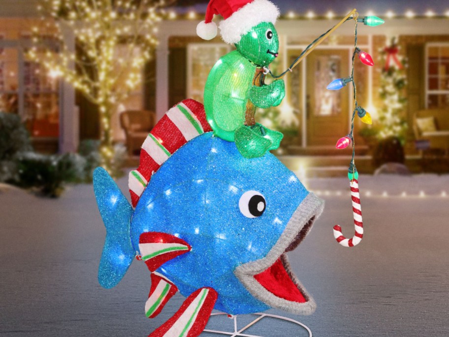 Christmas fish with turtle on head displayed in front of a house