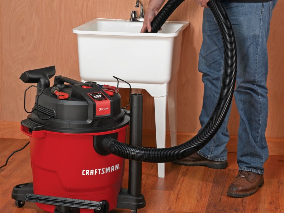 Craftsman 16-Gallon Wet_Dry Shop Vacuum w_ Accessorie with man holding the hose