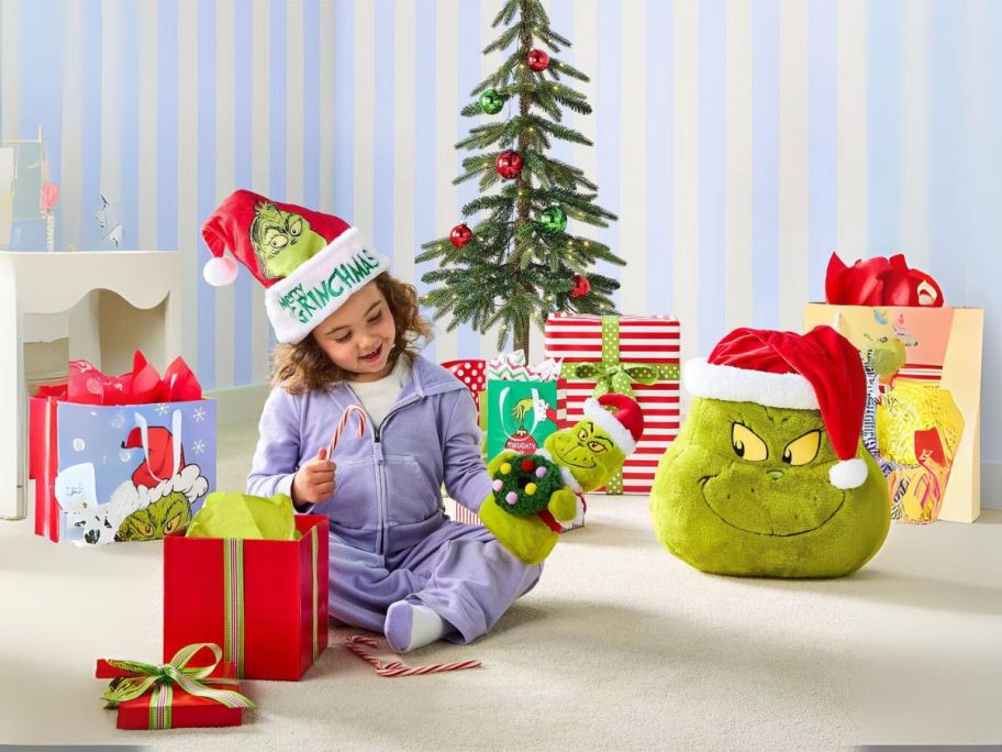 girl playing with Dr. Seuss The Grinch Holiday Collection