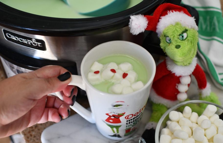 Hand holding Grinch Hot Chocolate