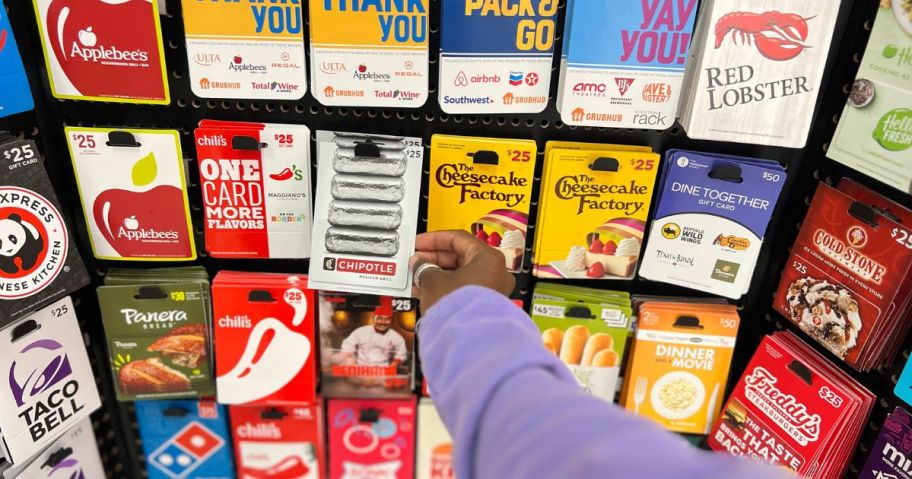 hand grabbing a gift card from a gift card display