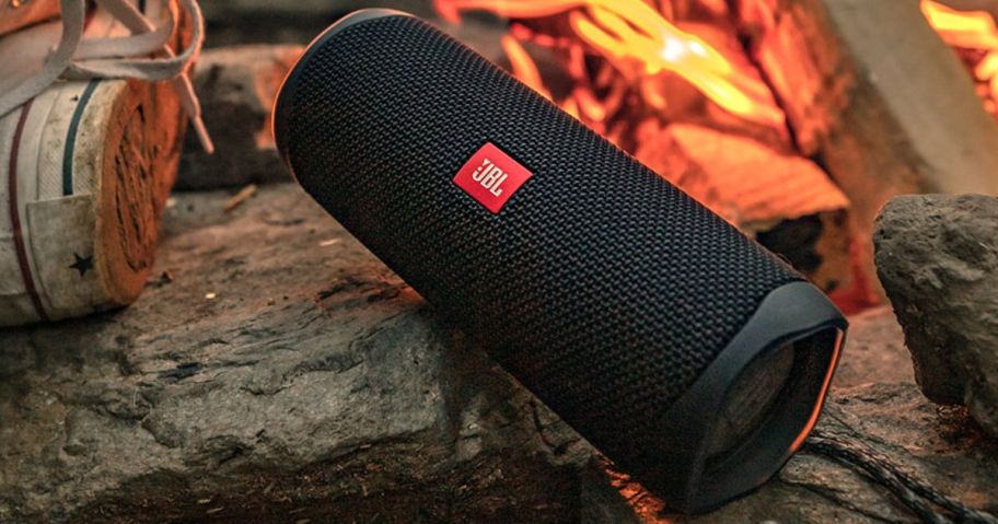 large wireless speaker outdoors near fire