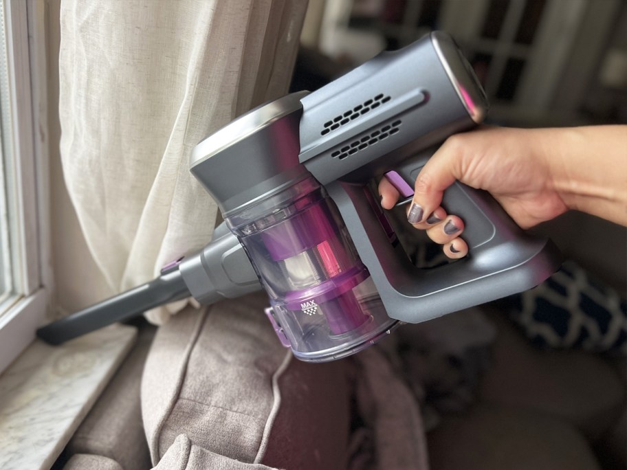 using hand vacuum on windowsill