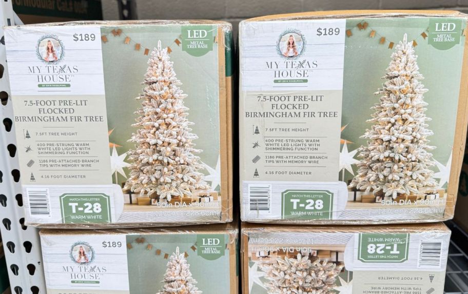 christmas tree boxes stacked on a shelf in a walmart store