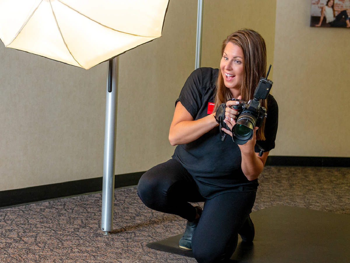 Photographer inside a photo studio holding up camera