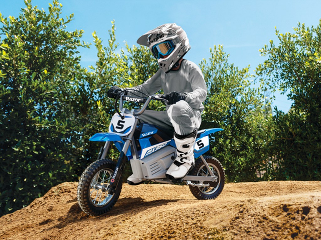 kid riding a blue razor brand dirt bike