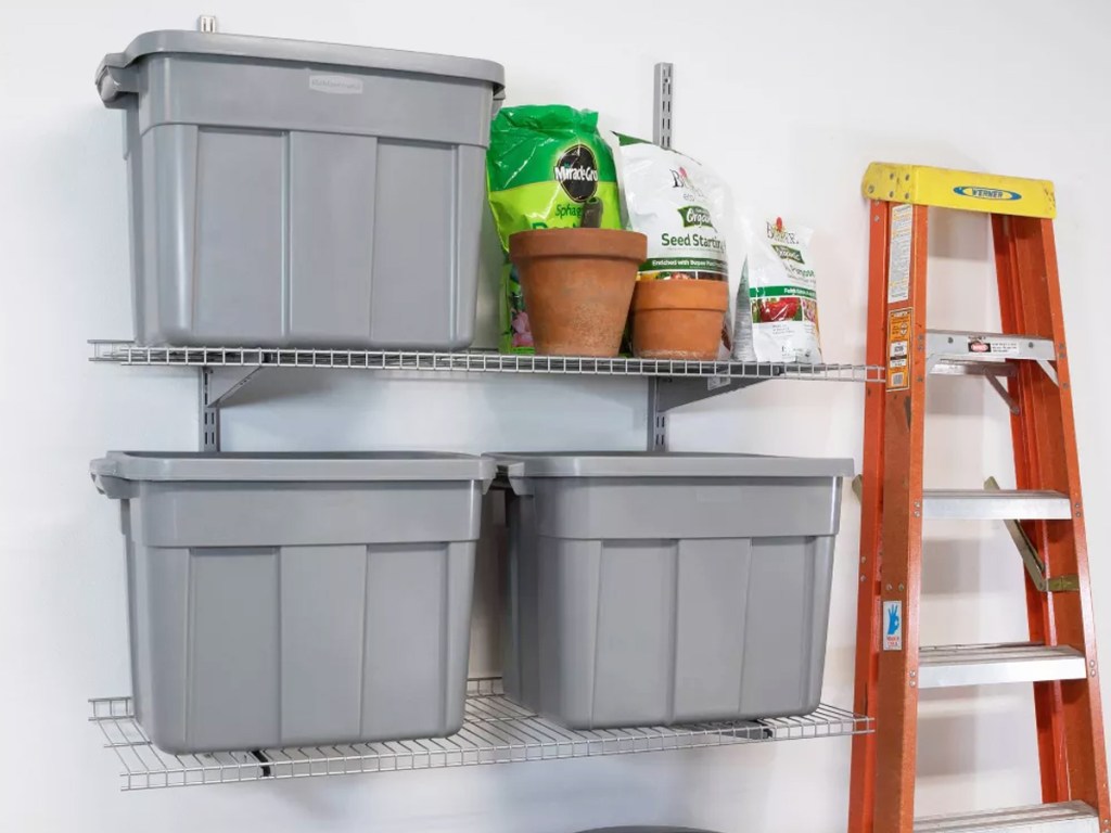 three grey storage totes on garage wall