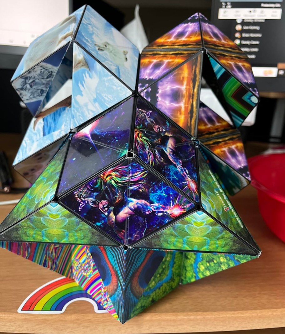 colorful puzzle toy sitting on wood desk with rainbow sticker