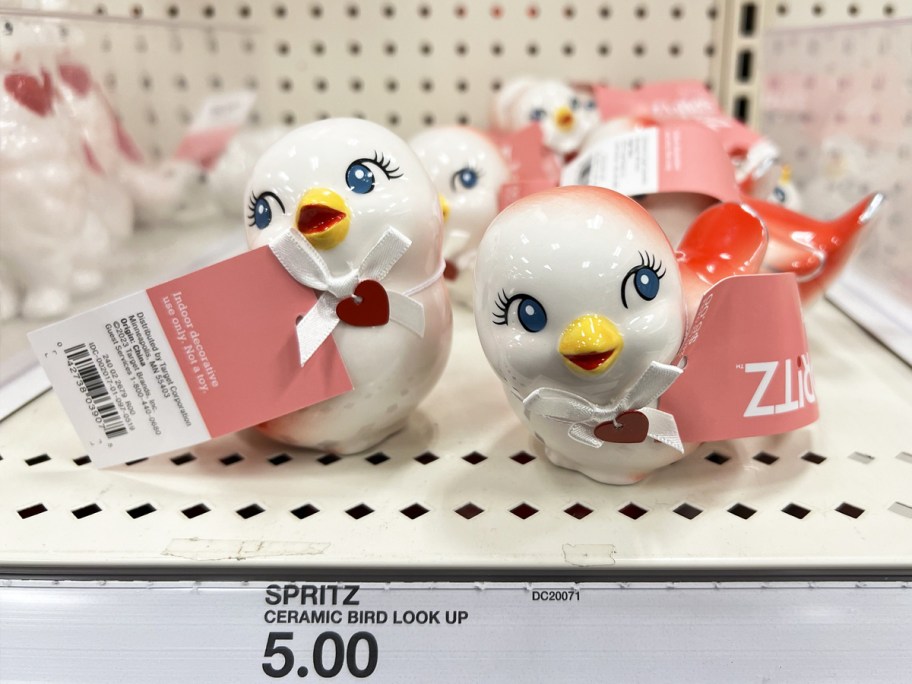 white and pink ceramic love birds on store shelf