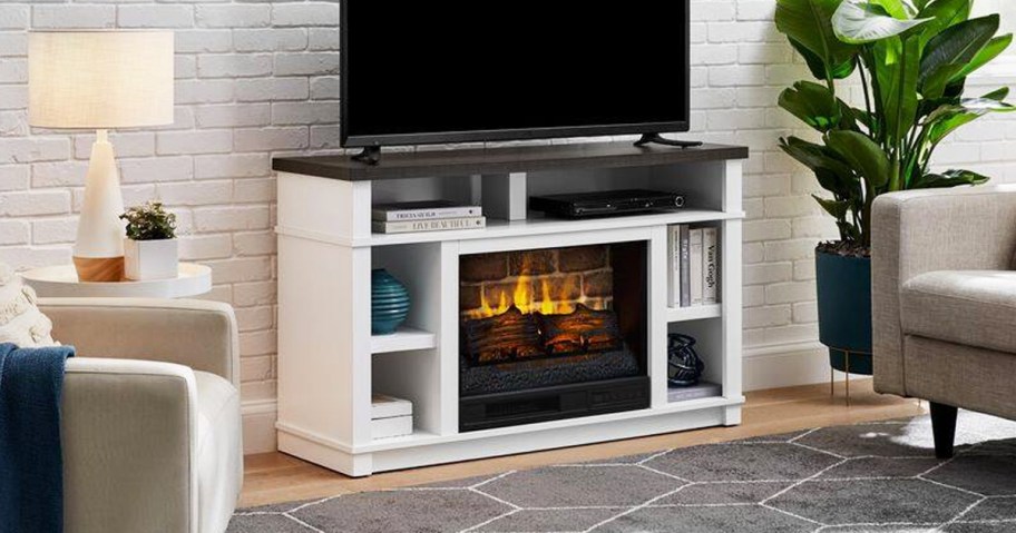 white tv stand with electric fireplace in center in living room