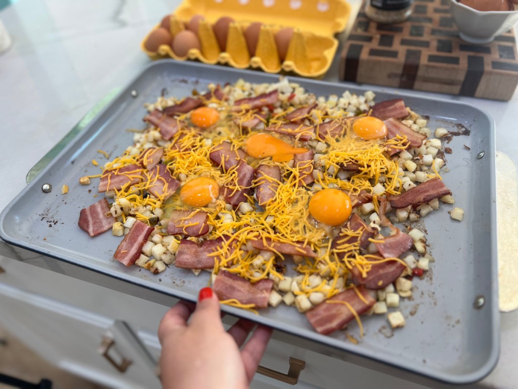 adding eggs to sheet pan breakfast