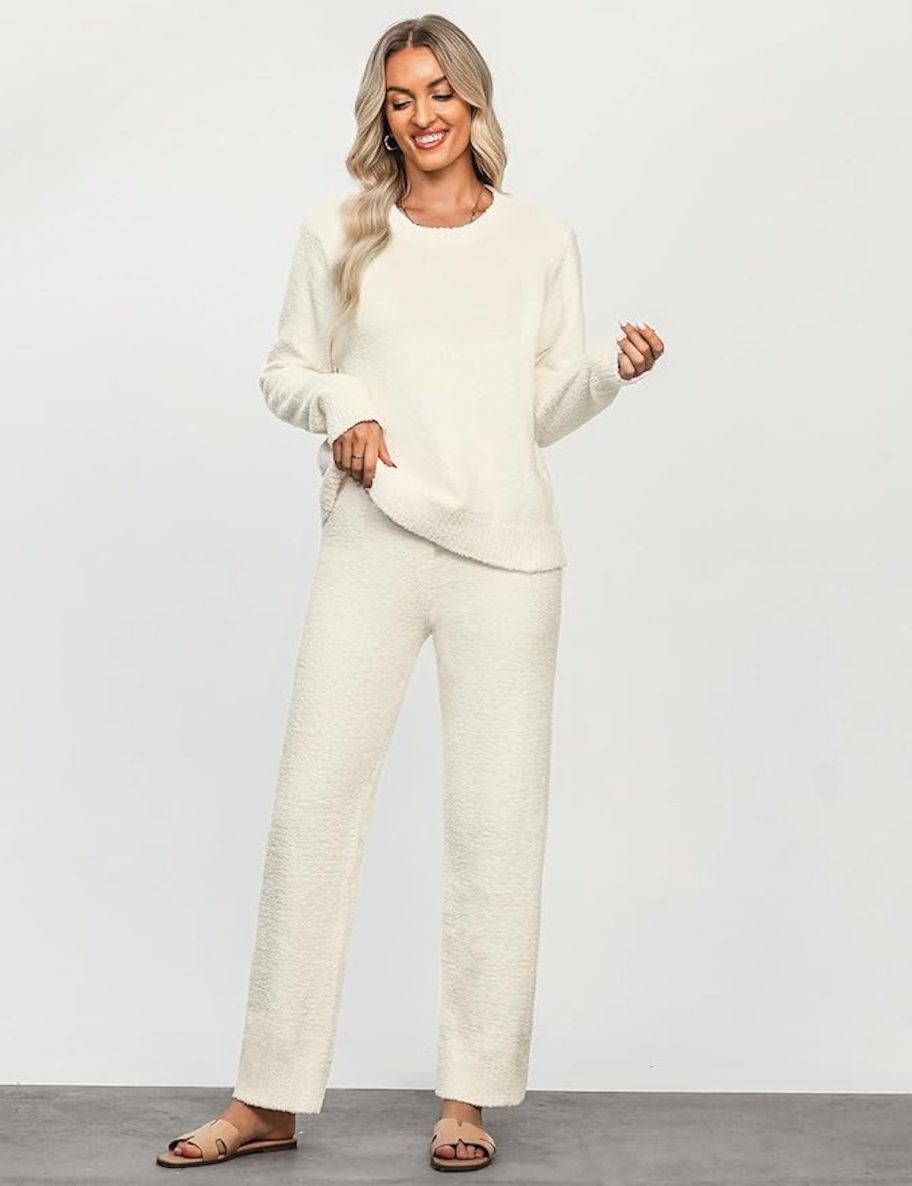 woman posing in cream colored loungewear set with gray background