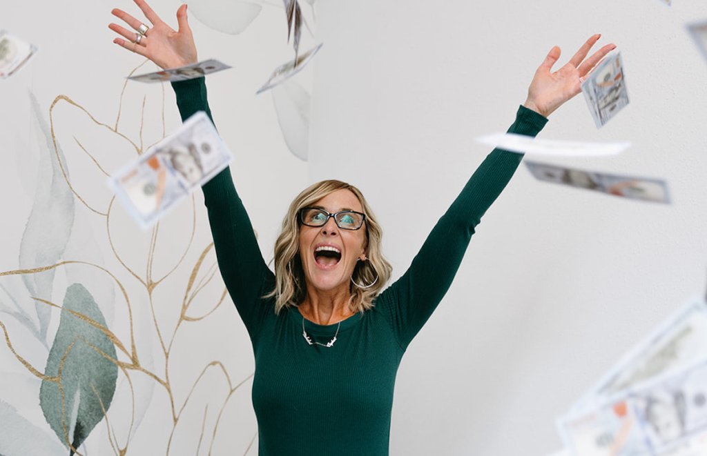 woman throwing money in air