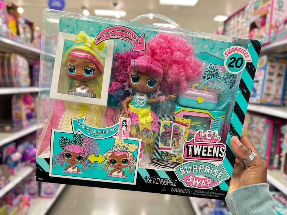 hand holding L.O.L. Surprise! Tweens Surprise Swap Curls-2-Crimps Cora Fashion Doll with 20+ Surprises