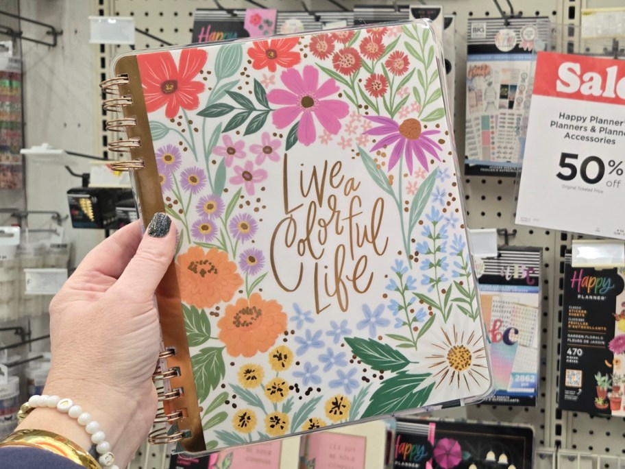 hand holding floral planner 