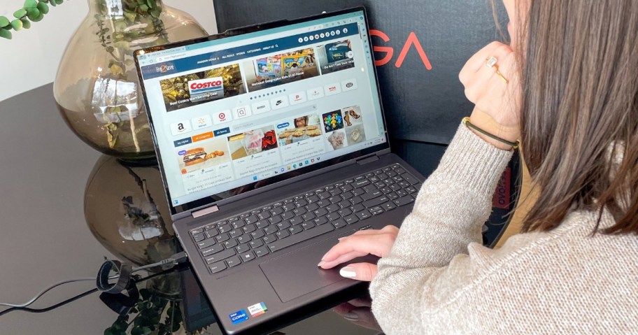 woman sitting at a table working on a laptop