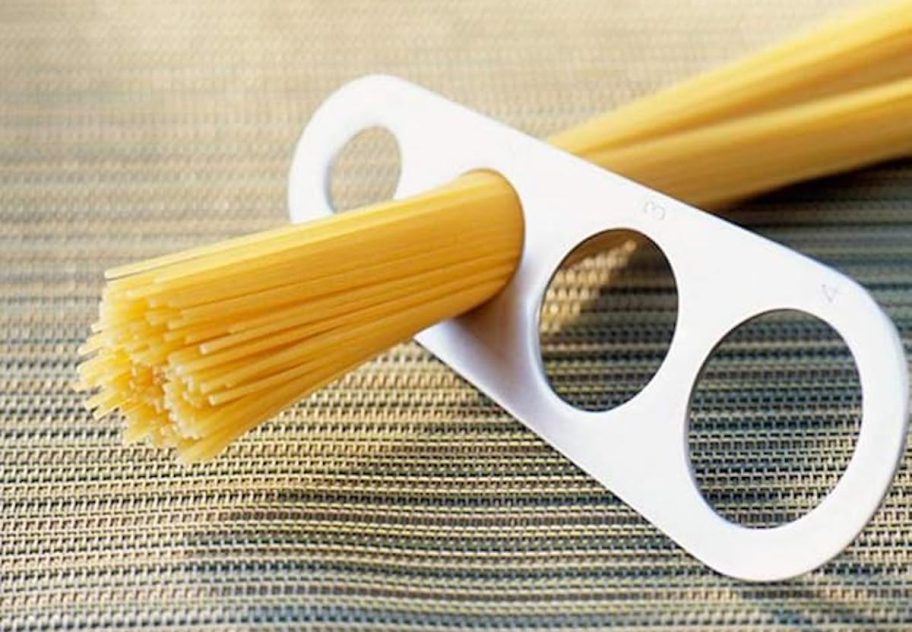 Pasta, measuring tool with spaghetti noodles in hole