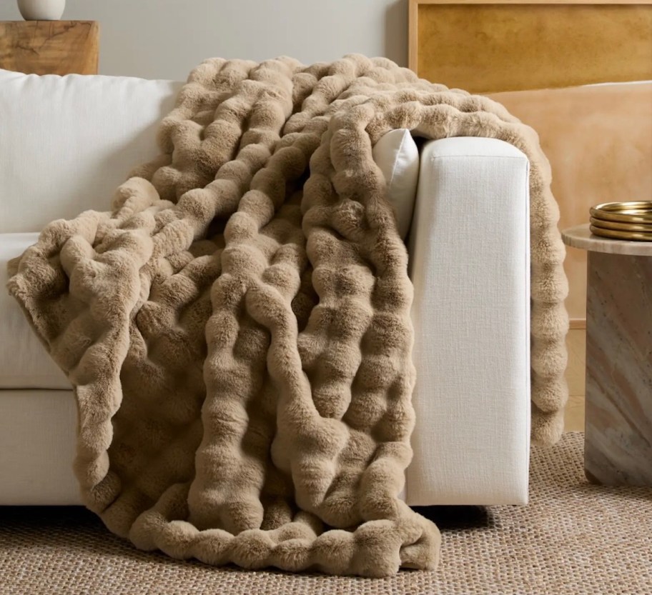 brown ruched throw blanket on white couch