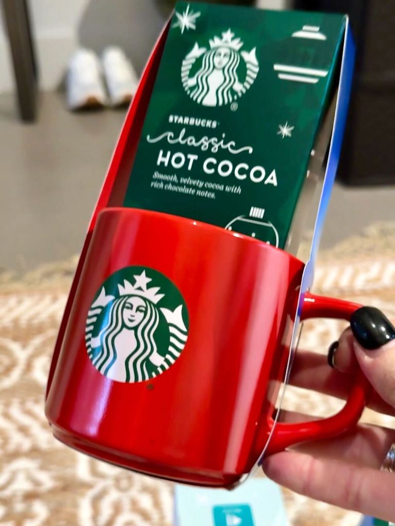 holding Starbucks mug with hot cocoa