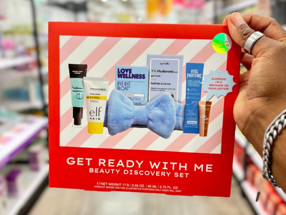 hand holding a red box with beauty products on the front that's a Get Ready With Me Beauty Discovery Set