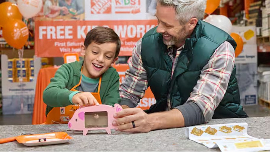 father and son building piggy bank at home depot kids workshop