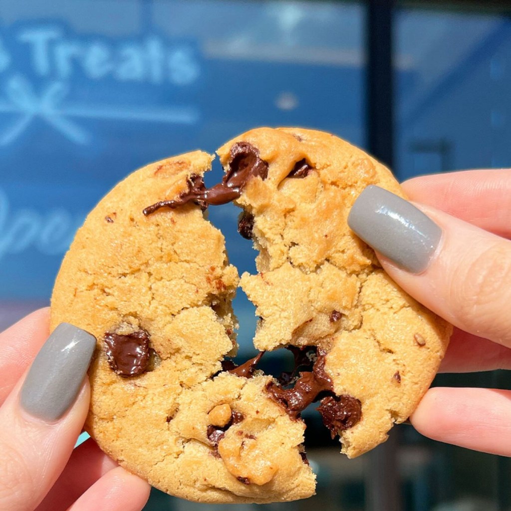 breaking a chocolate chip cookie in half