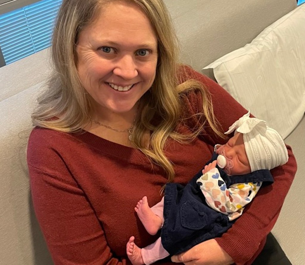 Woman holding baby on the couch 