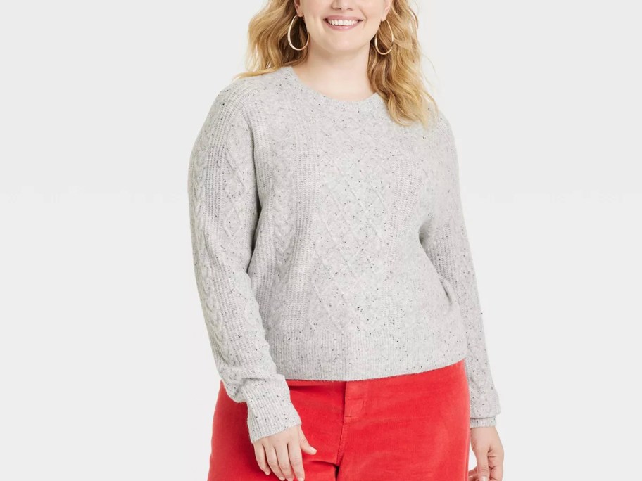 woman wearing gray sweater and red pants 