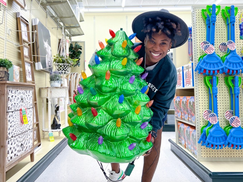 woman holding blow mold Christmas tree