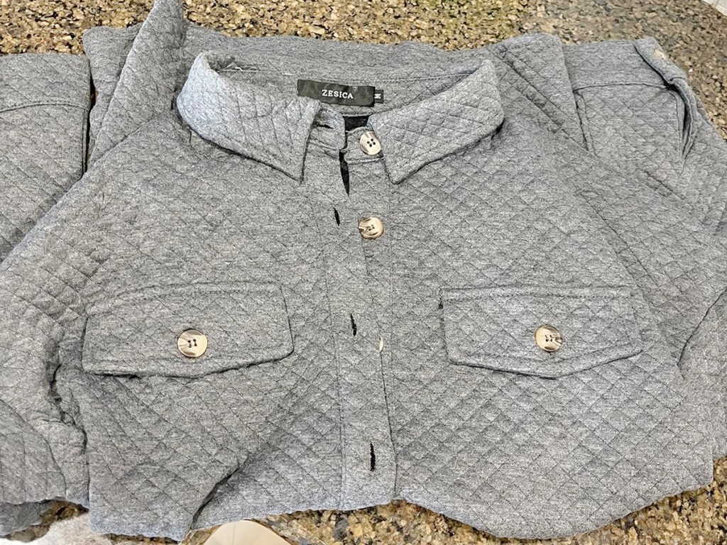 gray shacket folded in half on table