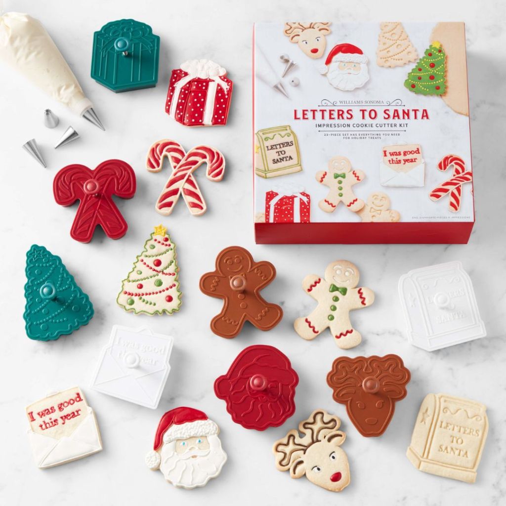 Williams Sonoma holiday Christmas cookie cutters laid out with box and piping bag