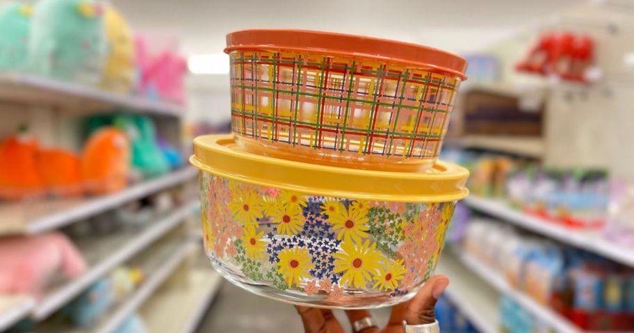 hand holding glass food containers with spring flowers and plaid designs