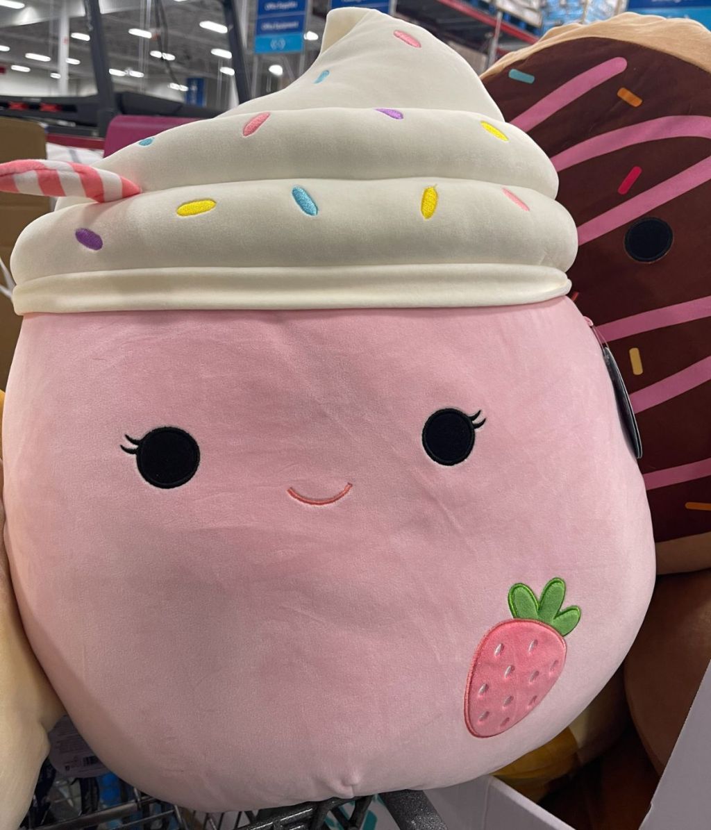 a large pink Strawberry Milkshake Squishmallow in a bin at Sam's Club 