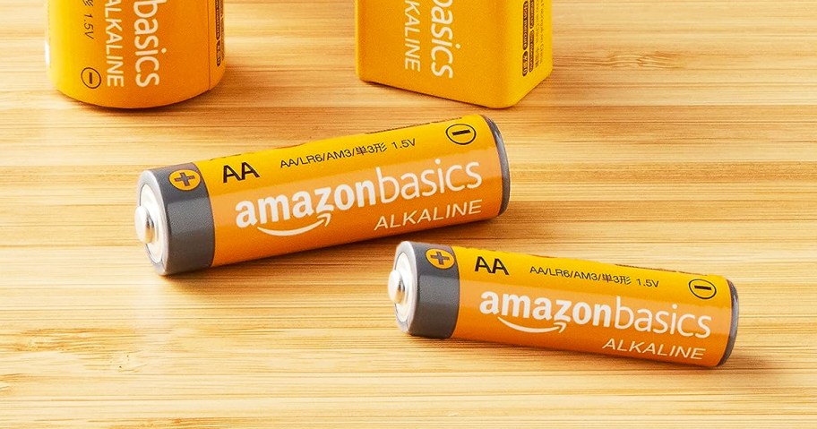 two amazonbasics AA batteries on wood table