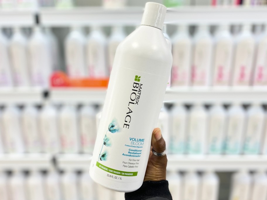 hand holding up a liter bottle of Biolage conditioner