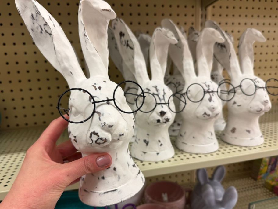 Hand holding a Distressed white reabbit decoration from Hobby Lobby