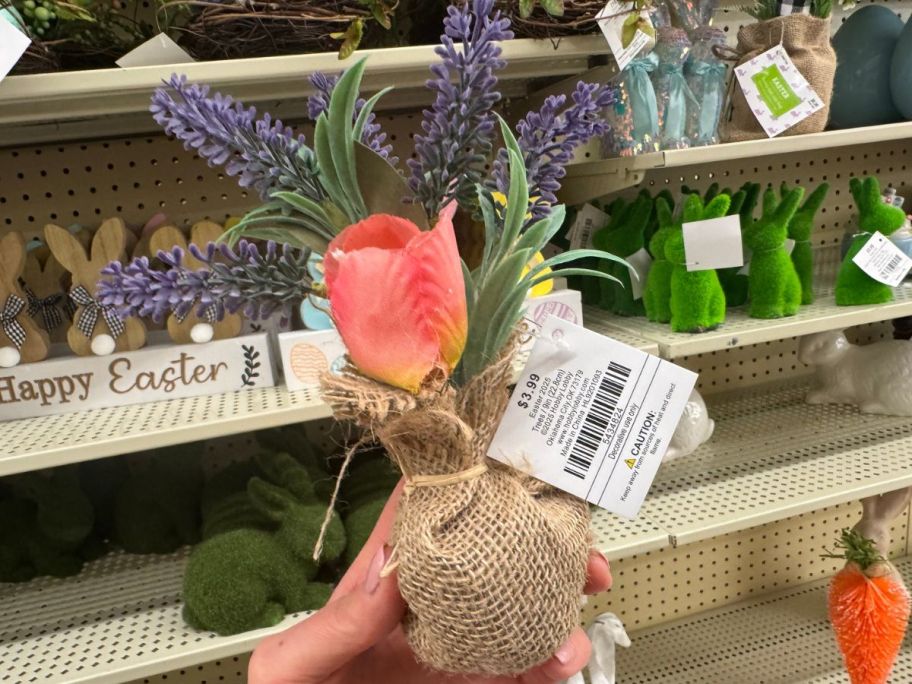 Hand holding a Hobby Lobby Faux Floral Tulip & Lavender Arrangement w/ Burlap Sack