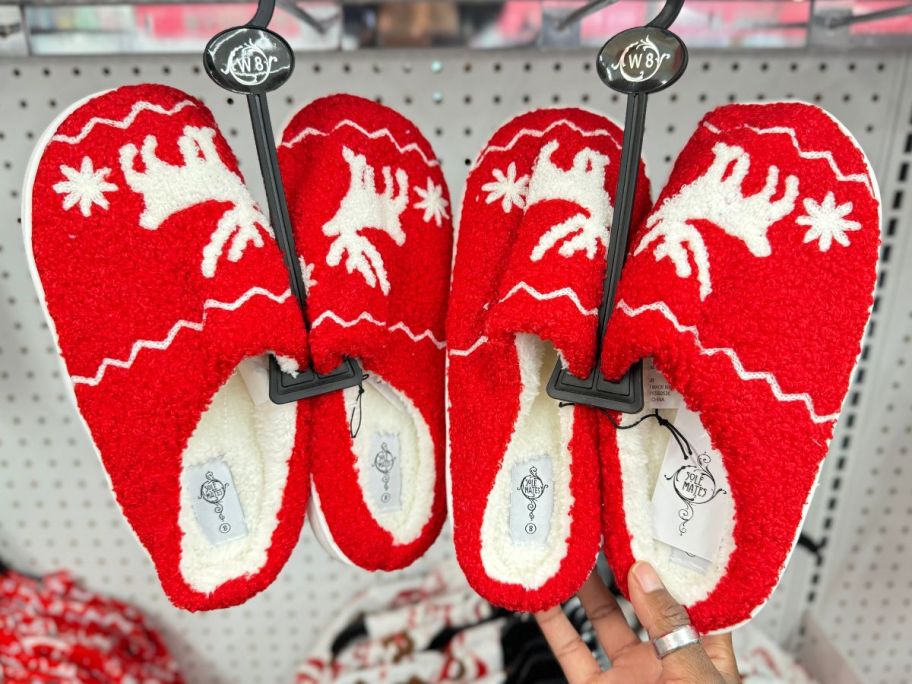 Ladies Sherpa Christmas Slippers hanging in store