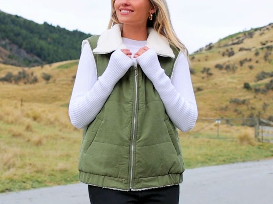 Woman wearing an army green Prettygarden reversible sherpa puffer vest